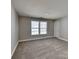 Cozy bedroom with soft carpet, bright window, and neutral walls at 5513 Hammermill Dr, Harrisburg, NC 28075