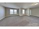 Spacious bonus room featuring a neutral color palette and plush carpet at 5513 Hammermill Dr, Harrisburg, NC 28075