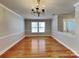 Traditional dining area with hardwood floors, decorative lighting, and bright windows at 5513 Hammermill Dr, Harrisburg, NC 28075