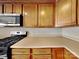 Functional kitchen with light wood cabinets, black appliances, and ample counter space at 5513 Hammermill Dr, Harrisburg, NC 28075