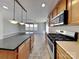 Modern kitchen featuring an island, stainless steel appliances, and tiled flooring at 5513 Hammermill Dr, Harrisburg, NC 28075