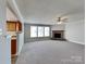 Inviting living room with a stone fireplace, ceiling fan, and carpeted floors at 5513 Hammermill Dr, Harrisburg, NC 28075