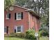 A close up of the side of a brick two-story house with mature trees in the background at 5635 Ruth Dr, Charlotte, NC 28215