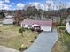 Aerial view of the charming home featuring a private drive, mature trees and landscaping at 609 Ben Rich St, Dallas, NC 28034