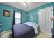 Comfortable bedroom with a ceiling fan, closet, and a plush bed with blue accents at 609 Ben Rich St, Dallas, NC 28034