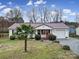 Inviting single-story home with metal roof, complemented by a well-maintained lawn and an attached garage at 609 Ben Rich St, Dallas, NC 28034