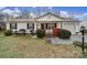 Charming single-story home featuring a metal roof, a cozy front porch, and an attached single car garage at 609 Ben Rich St, Dallas, NC 28034