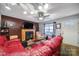 Comfortable living room featuring a fireplace, hardwood floors, and cozy red seating under bright lighting at 609 Ben Rich St, Dallas, NC 28034