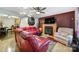 Spacious living room with a fireplace, a ceiling fan, hardwood floors, and comfortable red and tan seating at 609 Ben Rich St, Dallas, NC 28034