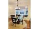 Elegant dining area with bay window, cushioned seating, and stylish chandelier at 645 Beaty St, Davidson, NC 28036