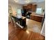 Functional kitchen with wood cabinetry, black appliances, and a breakfast bar at 645 Beaty St, Davidson, NC 28036