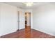 Neutral bedroom with hardwood floors, ceiling fan, and ensuite bathroom access at 7147 Brighton Park Dr, Mint Hill, NC 28227