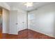 Bedroom features hardwood floors, neutral walls, closet, and plenty of natural light at 7147 Brighton Park Dr, Mint Hill, NC 28227