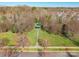 Aerial view showcases a charming green gazebo surrounded by trees and manicured lawn at 7147 Brighton Park Dr, Mint Hill, NC 28227