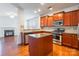 Modern kitchen with stainless steel appliances, granite countertops, central island, and hardwood floors at 7147 Brighton Park Dr, Mint Hill, NC 28227