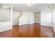 Open-concept living space with gleaming hardwood floors and neutral color scheme at 7147 Brighton Park Dr, Mint Hill, NC 28227