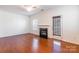 Inviting living room features a fireplace, ceiling fan, and a door to the outside at 7147 Brighton Park Dr, Mint Hill, NC 28227