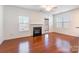 Bright living room with fireplace, ceiling fan, and access to the outdoors at 7147 Brighton Park Dr, Mint Hill, NC 28227