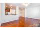 Bright, open living area with wood floors flowing into the kitchen and dining area at 7147 Brighton Park Dr, Mint Hill, NC 28227