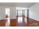 Bright primary bedroom boasting hardwood floors and large windows with modern coverings at 7147 Brighton Park Dr, Mint Hill, NC 28227