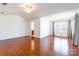 Spacious primary bedroom with hardwood floors, natural light and ensuite bathroom access at 7147 Brighton Park Dr, Mint Hill, NC 28227