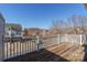 Rear patio features wood flooring and a railing with a view of the street and neighboring buildings at 7147 Brighton Park Dr, Mint Hill, NC 28227