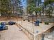 The backyard features a stone patio with a firepit, grilling area, and ample seating for outdoor entertaining at 7219 Morningdew Ct, Denver, NC 28037