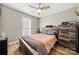 Comfortable bedroom featuring a ceiling fan, hardwood floors, and natural light at 7219 Morningdew Ct, Denver, NC 28037