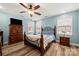 Well-lit bedroom with hardwood floors, ceiling fan, and classic furnishings at 7219 Morningdew Ct, Denver, NC 28037