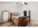 Vaulted ceiling bedroom with wood frame bed, decorative mirror, and ensuite bathroom at 7219 Morningdew Ct, Denver, NC 28037