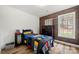 Charming bedroom with natural light, wood accent wall, and hardwood floors at 7219 Morningdew Ct, Denver, NC 28037