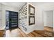Bright entryway with wood-look flooring, a decorative accent wall, and a stylish front door with sidelights at 7219 Morningdew Ct, Denver, NC 28037