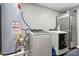 Functional laundry room with modern washer, dryer, water heater, and extra refrigerator at 7219 Morningdew Ct, Denver, NC 28037
