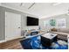 Bright living room with a large television, modern furniture, and natural light at 7219 Morningdew Ct, Denver, NC 28037