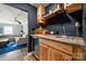 Charming wet bar with wood countertop, beverage fridge, and easy access to living area at 7219 Morningdew Ct, Denver, NC 28037