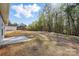 Large grassy backyard with an adjacent house and mature trees in the background at 844 Westminster Dr, Statesville, NC 28677