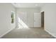 Bright bedroom with neutral carpet, white trim, and natural light from the window at 844 Westminster Dr, Statesville, NC 28677