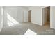 Bedroom with neutral carpet, open doors to closet and bathroom at 844 Westminster Dr, Statesville, NC 28677