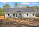 Rear of house featuring vinyl siding and a grassy backyard with mature trees at 844 Westminster Dr, Statesville, NC 28677