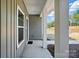 Covered front porch with white columns, offering a glimpse of the yard and a sense of entry at 844 Westminster Dr, Statesville, NC 28677