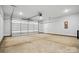 Spacious two car garage featuring an automatic door, concrete floor and bright overhead lighting at 844 Westminster Dr, Statesville, NC 28677