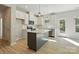 Modern kitchen featuring white cabinets, a gray island, stainless steel appliances, and sleek countertops at 844 Westminster Dr, Statesville, NC 28677