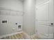 Functional laundry room with wire shelving and wood-look laminate flooring at 844 Westminster Dr, Statesville, NC 28677