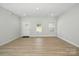 Spacious living room with ample natural light, showcasing a clean and modern interior with wood-look floors at 844 Westminster Dr, Statesville, NC 28677