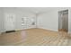 Spacious living room with ample natural light, showcasing a clean and modern interior with wood-look floors at 844 Westminster Dr, Statesville, NC 28677