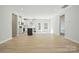 Bright, open living space showcasing modern flooring and ample natural light flowing into the kitchen at 844 Westminster Dr, Statesville, NC 28677