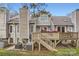 Charming backyard featuring a wooden deck with stairs and hot tub, perfect for outdoor relaxation at 8904 Saint Pierre Ln, Charlotte, NC 28277