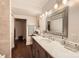 Neutral-toned bathroom with marble countertop, modern mirror and recessed lighting at 8904 Saint Pierre Ln, Charlotte, NC 28277