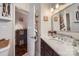 Bathroom with marble countertop vanity, modern mirror, and convenient storage shelves at 8904 Saint Pierre Ln, Charlotte, NC 28277