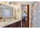 Bathroom with a marble countertop vanity, a modern mirror, and a patterned shower curtain at 8904 Saint Pierre Ln, Charlotte, NC 28277